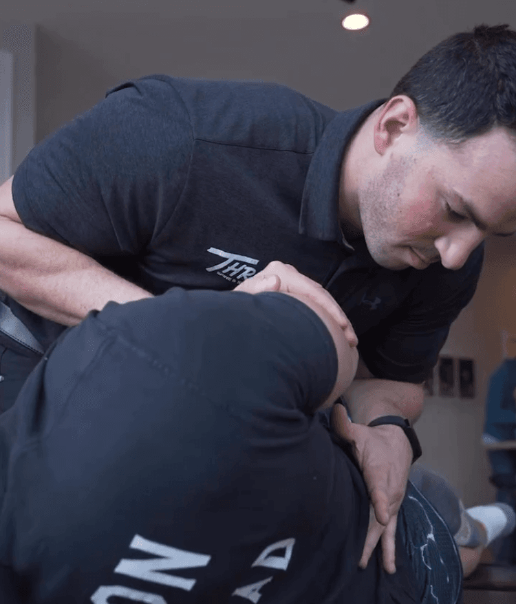 Person receiving chiropractic care at Thrive