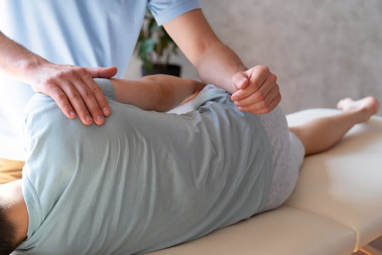 Close up of a physiotherapist helping a patient with pain