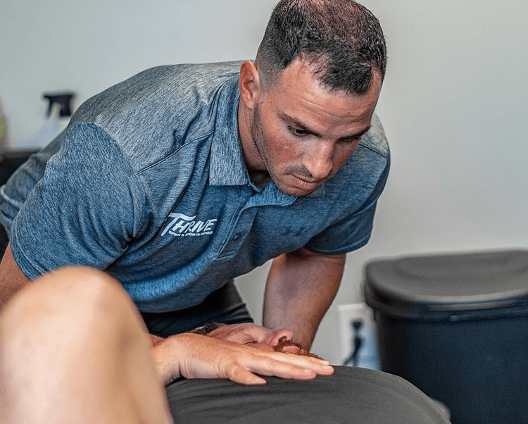 Person receiving chiropractic care at Thrive