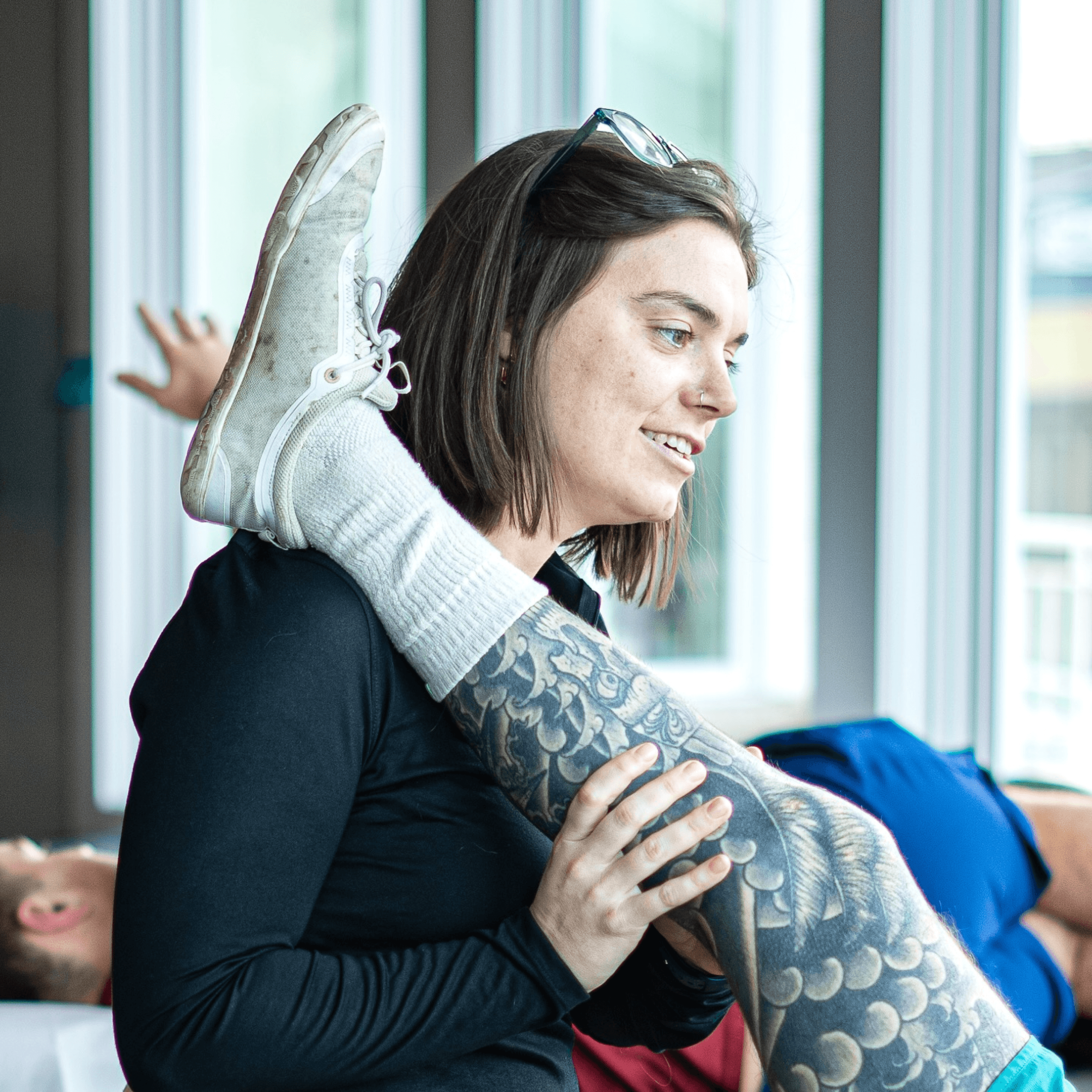 Woman PT stretching man's leg