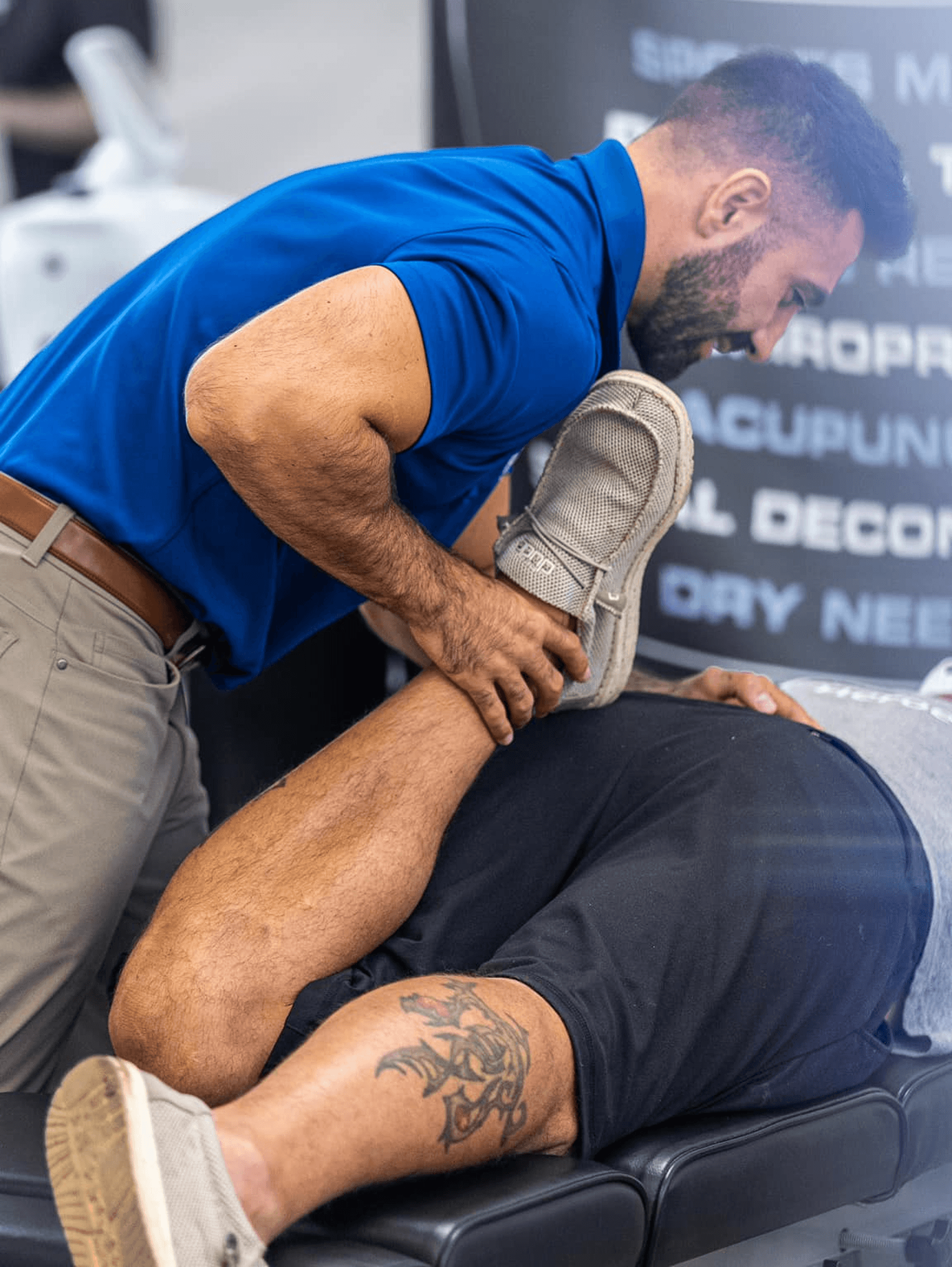 Woman PT stretching man's leg