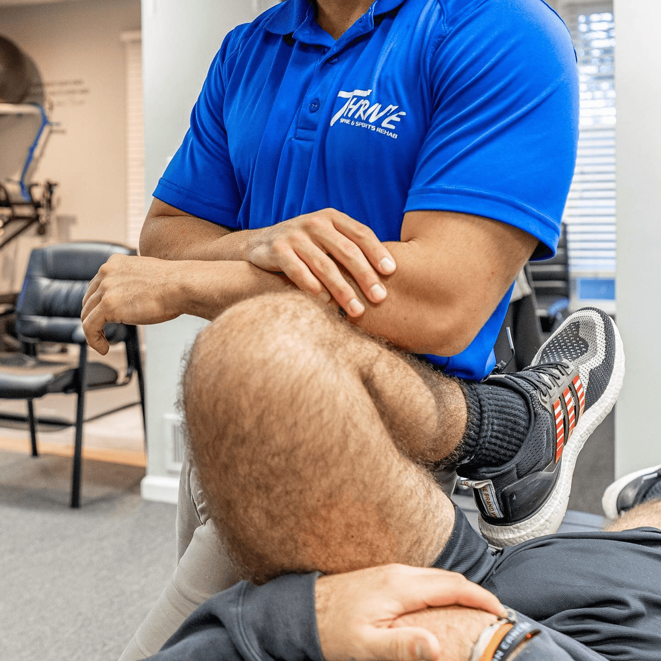 Physical therapist stretching a leg