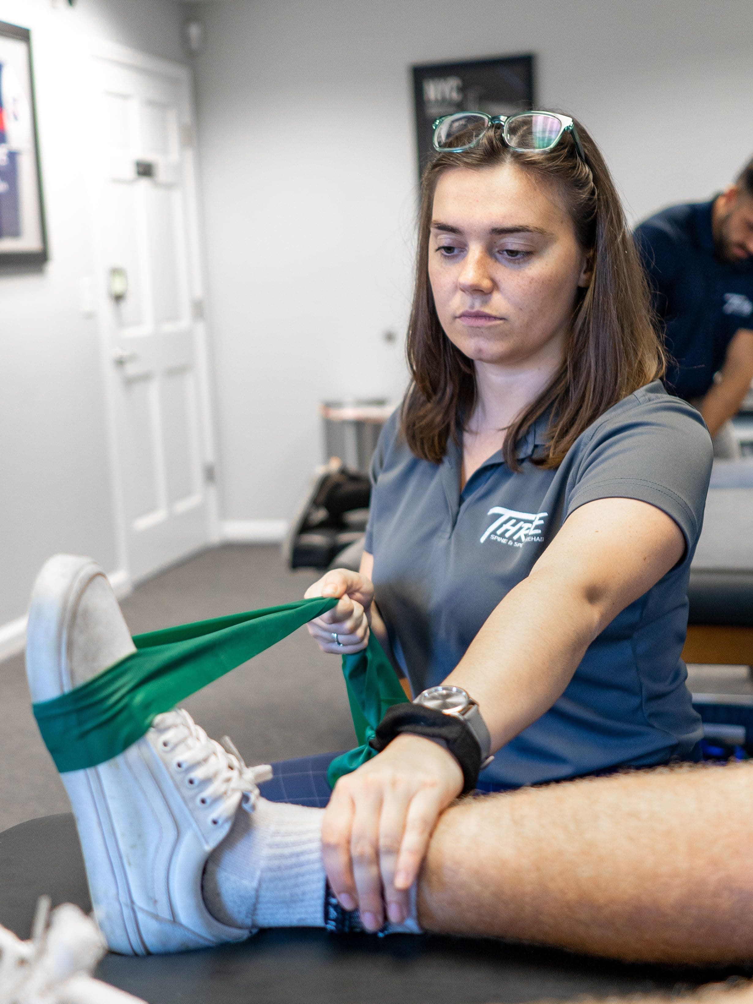 Physical therapist stretching a leg