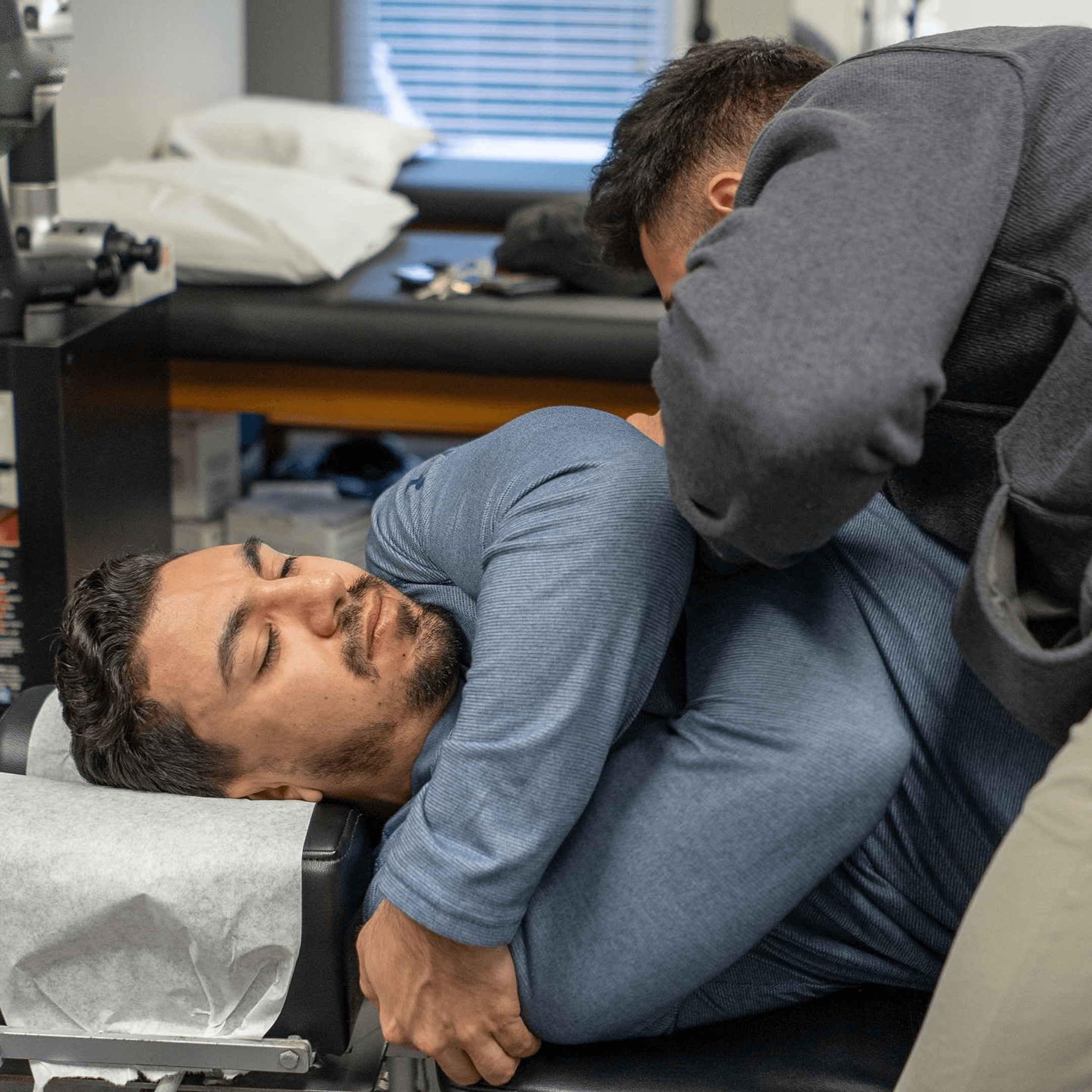 Patient receiving a neck adjustment at Thrive Freehold